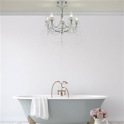 image of a bathroom chandelier hanging over a grey bathtub