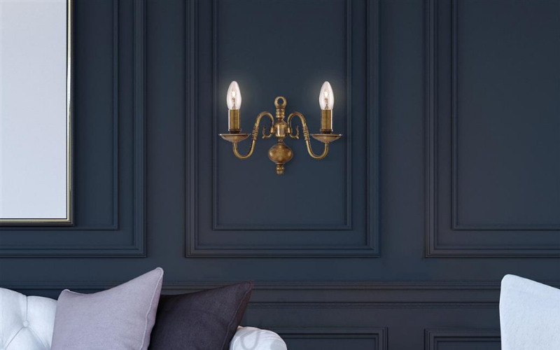image of a brass wall lamp on a blue background